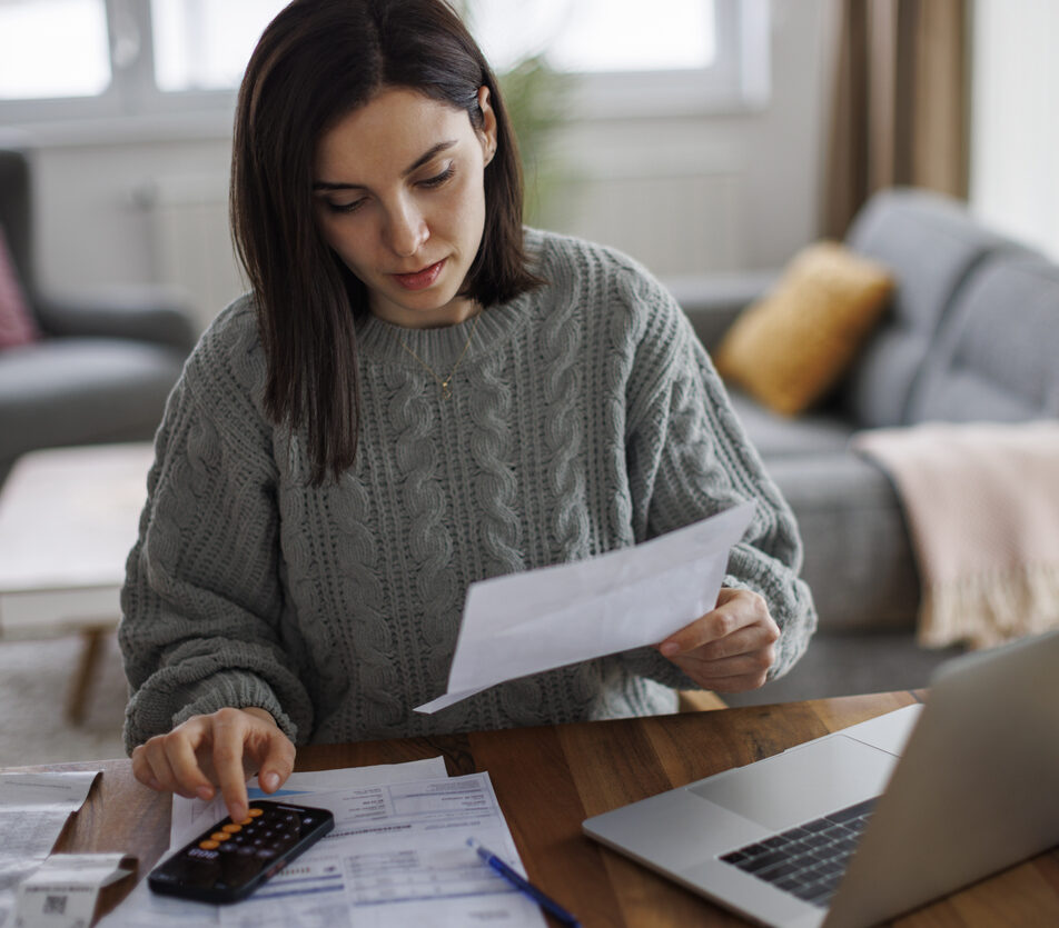 Woman checking her monthly expenses and statements at home