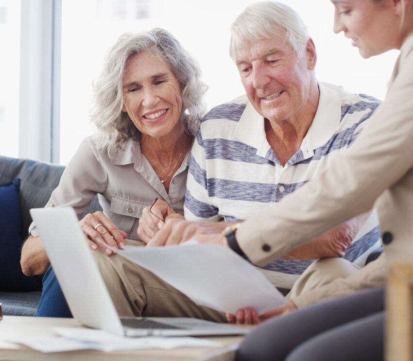 Senior couple, accountant and documents with laptop for retirement plan, annuity or insurance on sofa. Elderly man, woman or financial advisor with paperwork for discussion on pension funds or assets