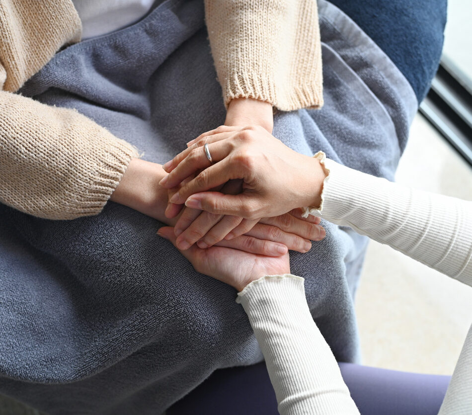 No words are needed when compassion speaks through touch — a friend’s steady hands wrap around the one who’s fighting, offering comfort only love can give