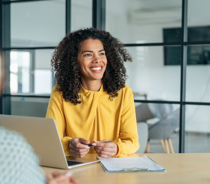 A candidate confidently presents their resume during a job interview with a panel of professionals. Company owner on a meeting with employee. Middle aged businesswoman in a conversation with a colleague. Lawyer consulting client during formal meeting. Job interview and hiring process.