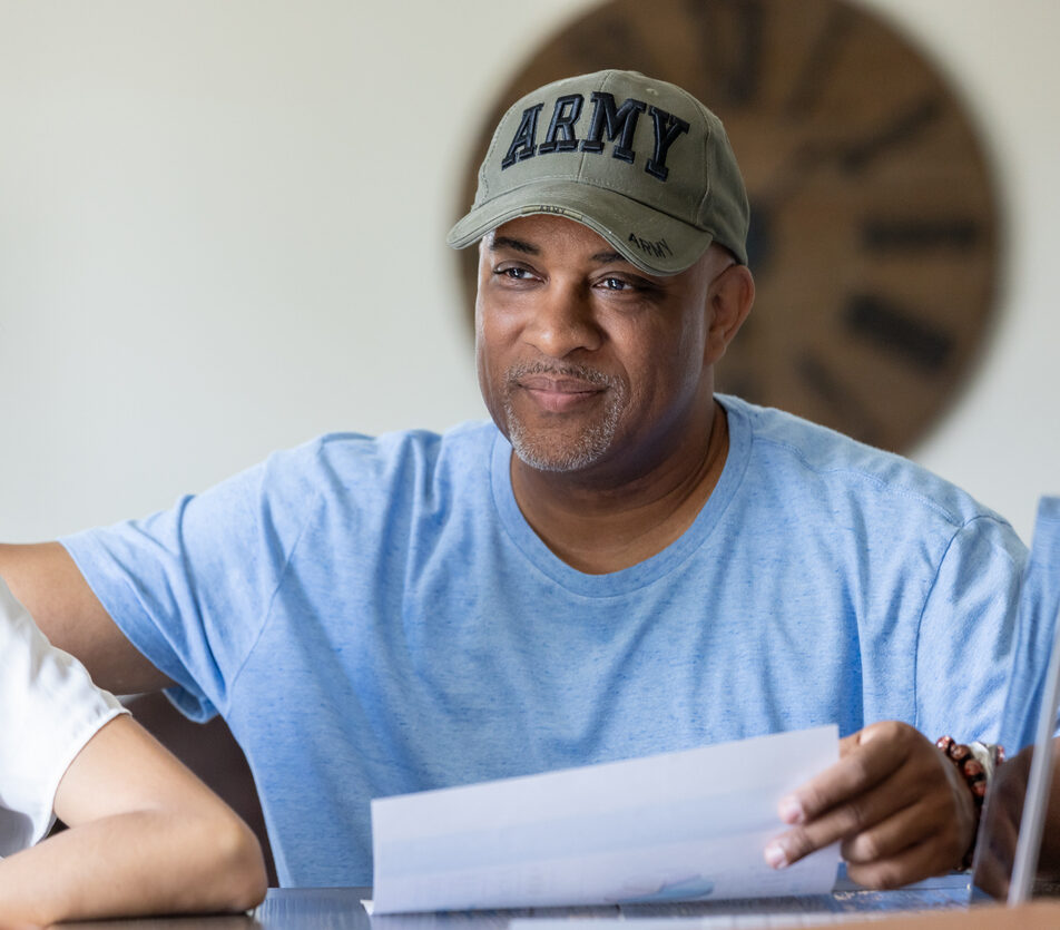 Veteran reviews contract while he and his wife meet with their financial advisor or insurance agent