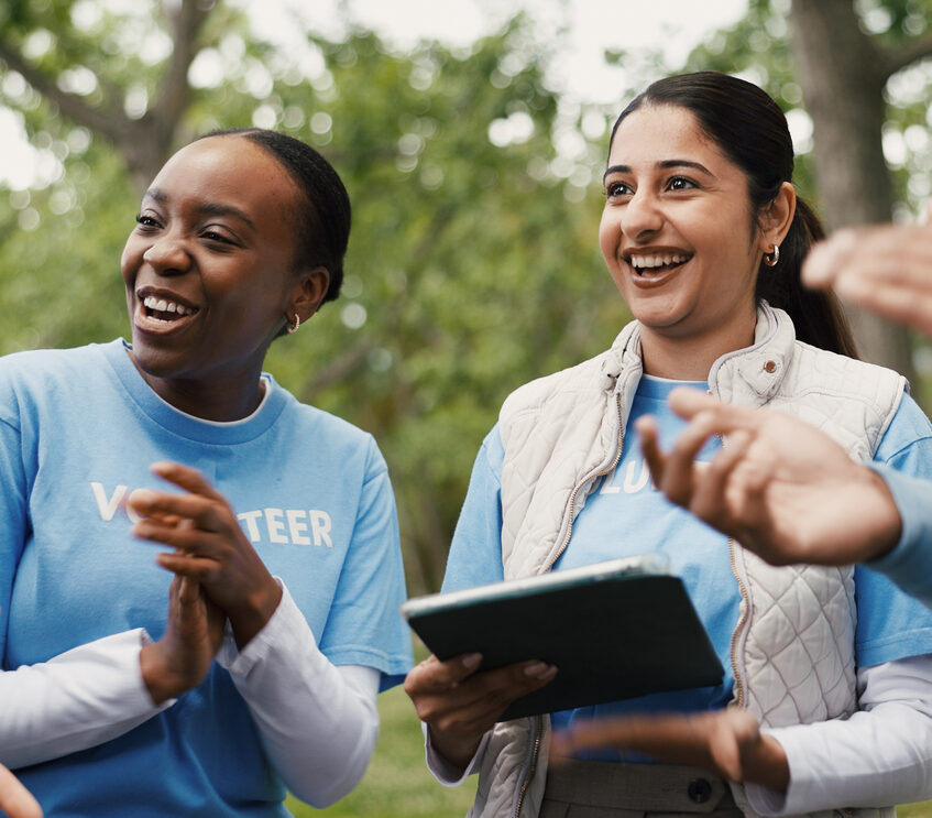 Applause, tablet and volunteer people outdoor for food drive celebration, motivation or success. App, charity and support with excited friends clapping in park together for community outreach